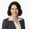 Woman in professional attire with a neutral background
