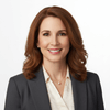 Woman in professional attire with a neutral background