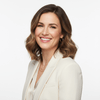 Woman in a white blazer with a blurred background