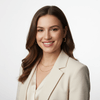 Woman in a white blazer against a neutral background